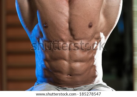 Abdominal Muscle Close-Up - Young Man Performing Hanging Leg Raises Exercise - One Of The Most Effective Ab Exercises