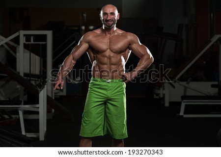 Portrait Of A Physically Fit Mature Man In A Healthy Club With Dramatic Lighting