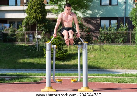 Street Workout - Handsome Muscular Man Workout In The Park