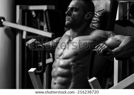 Male Bodybuilder Doing Heavy Weight Exercise For Chest