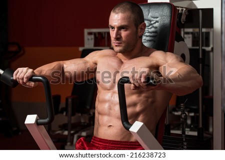 Male Bodybuilder Doing Heavy Weight Exercise For Chest