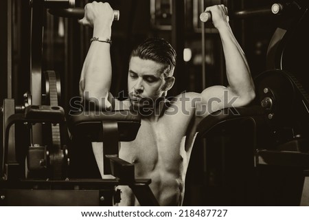 Male Bodybuilder Doing Heavy Weight Exercise For Biceps