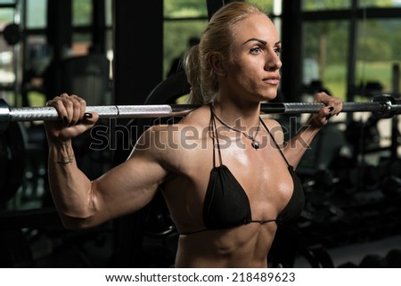 Female Bodybuilder Doing Heavy Weight Exercise For Legs Barbell Squat