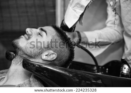 Hairdresser Washing Man Head In Barber Shop - Hairstylist Hairdresser Washing Customer Hair - Young Man Relaxing In Hairdressing Beauty Salon