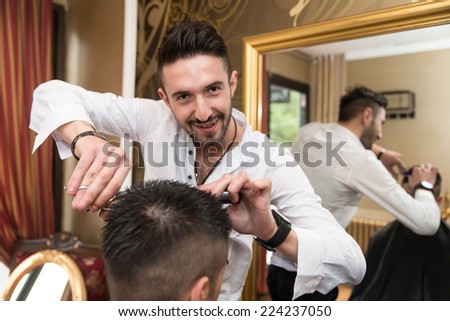Hairdresser Trimming Black Hair With Scissors - Handsome Young Hairdresser Giving A New Haircut To Male Customer At Parlor