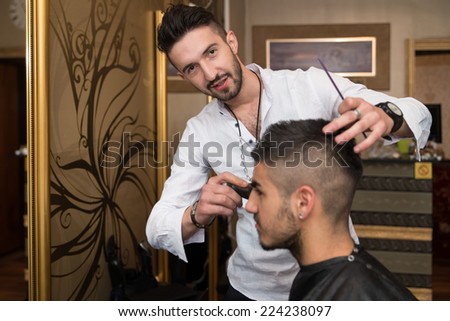 Hairdresser Cleaning Young Man After Haircut - Handsome Young Hairdresser Giving A New Haircut To Male Customer At Parlor
