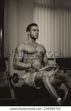 Male Fitness Athlete Doing Heavy Weight Exercise For Back