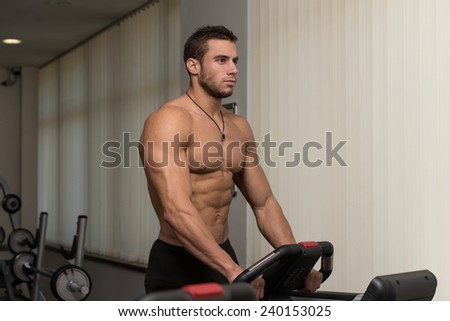 Man Running On Treadmill At A Health Club