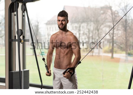Handsome Man Is Working On His Chest With Cable Crossover In A Modern Gym