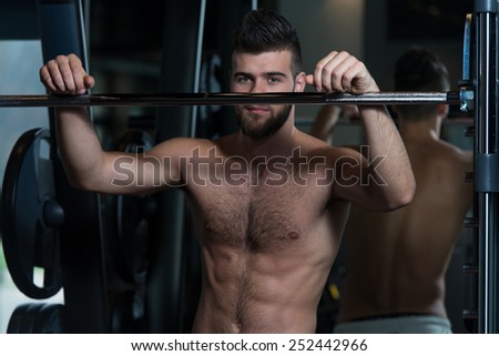 Portrait Of A Physically Fit Young Man Resting In A Health Modern Club