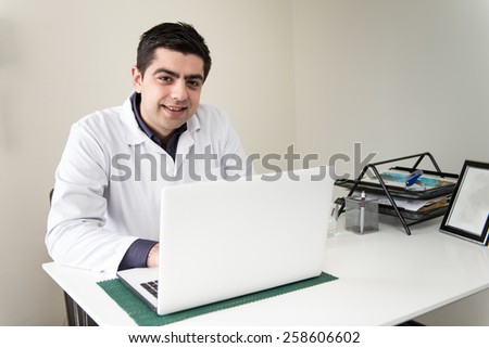 Doctor In The Dentist Office With Laptop