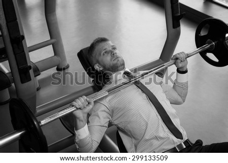 Business Man In Gym Exercising Chest On The Bench Press