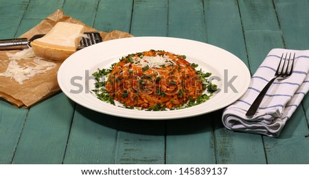 Yiouvetsi - One Pot Greek Ground Lamb with Kritharaki (Orzo), Tomato, Cinvamon, Cloves, Parsley and Parmesan Cheese on Rustic Turquoise table