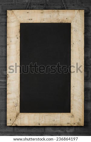 Vintage chalkboard blackboard in reclaimed old wooden frame gray brick wall with copy space