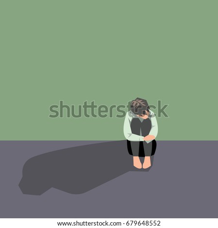 Depressed man sit and  hugging his knees. Concept of sad people