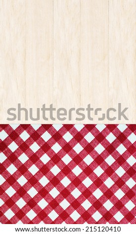 Wooden table covered with red checked tablecloth, top view, background, display, template