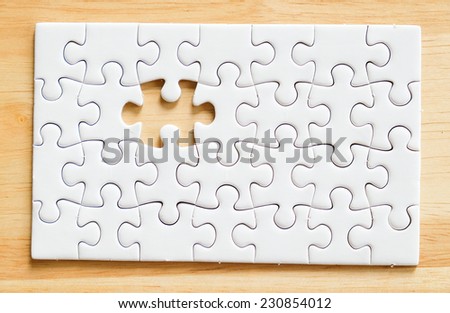 Jigsaw puzzle with missing one piece on wood, for business concepts