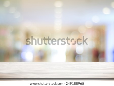 Empty white table and blurred store with bokeh background, product display template.