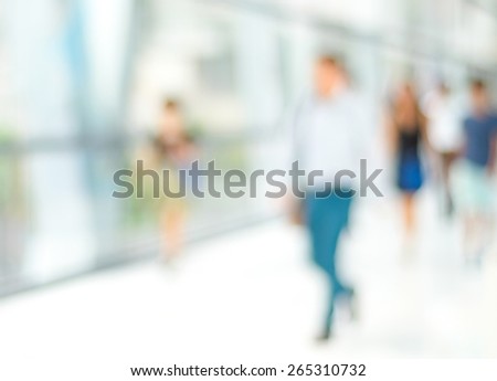 Blurred people inside office building background, business concept