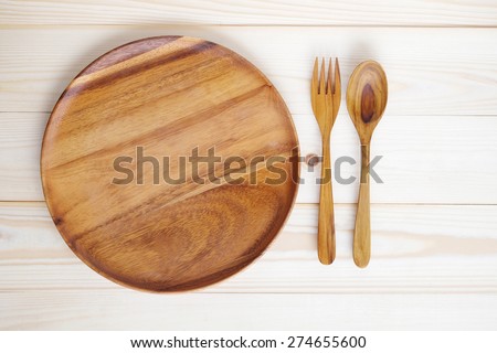 Empty wooden plate with fork and spoon on wood table, food display montage