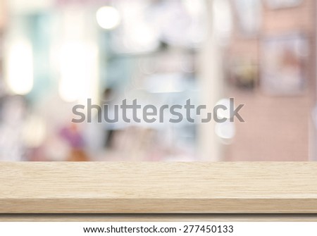 Empty wood table and blurred cafe with bokeh light background, product display montage