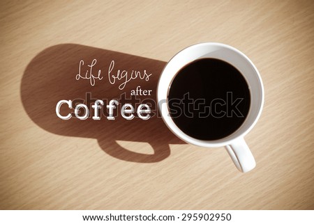 Life begins after coffee: Quote with coffee cup on wood background