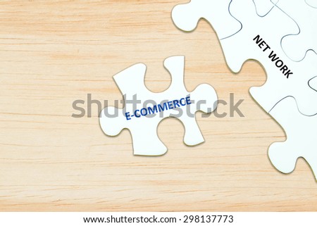 E-commerce and network words on jigsaw puzzle background, digital marketing, success in business concept