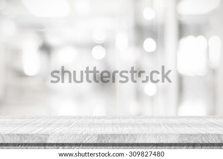 Empty white table and blurred abstract background with bokeh light, product display template, black and white tone