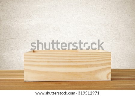 Wood storage box on table over cement wall background, product display montage