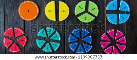 colorful math fractions and apples as a sample on brown wooden background or table. interesting math for kids. Education, back to school concept. Geometry and mathematics materials. Сток-фото © 
