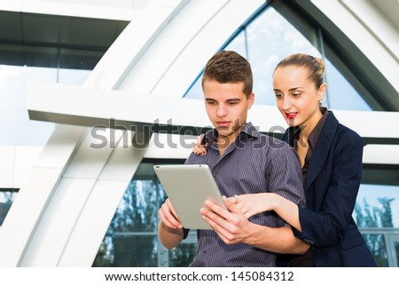 Businessman and businesswoman using a tablet pc together