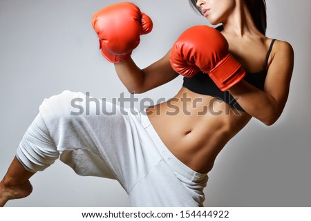 beautiful woman with the red boxing gloves, studio shot
