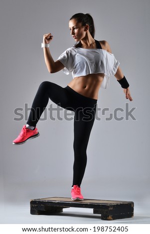 beautiful fitness woman working out, studio shot