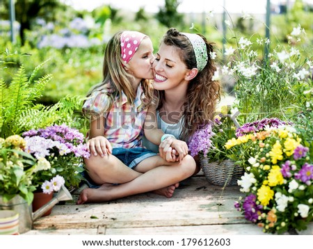 Mom and daughter have fun in the work of gardening