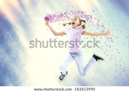 Little happy girl holding flowers while jumping on air, in spring