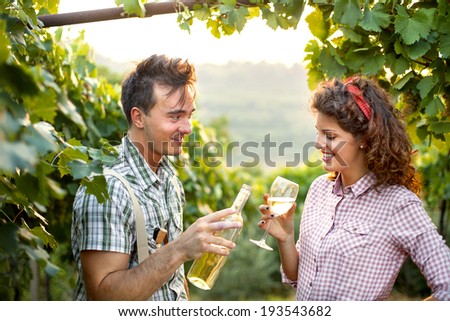 farming couple drinking a glass of wine after the harvest