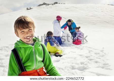 young boy having fun in the snow