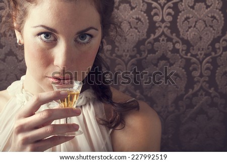 dreaming woman drinks a glass of excellent Scotch whisky