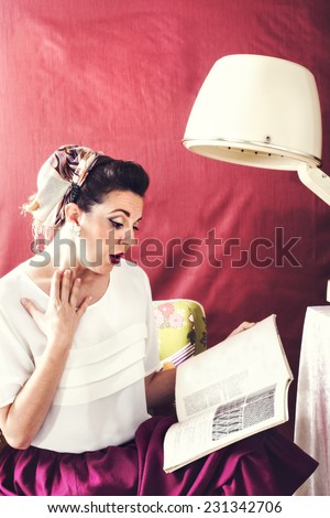 vintage housewife reads magazine in in Beauty salon