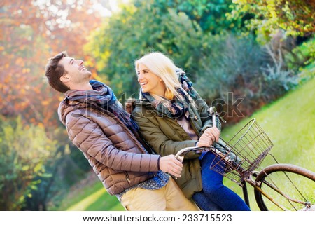 autumn. couple cycling in park