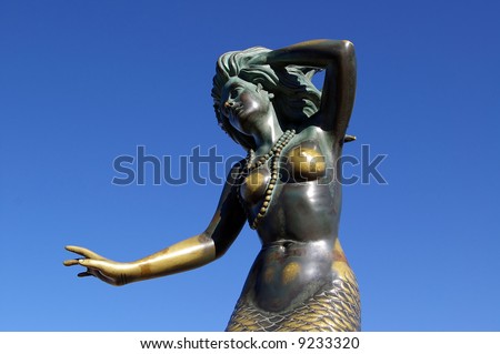 Tarnished Green Mermaid Statue In Mexico, Showing Breasts Against Clear ...