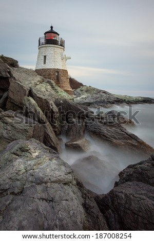 Long exposure sunset picture of Castle Hill Lighthouse at night in Newport, Rhode Island, USA on a rocky coastline of the Atlantic ocean. / Castle Hill Lighthouse at Sunset