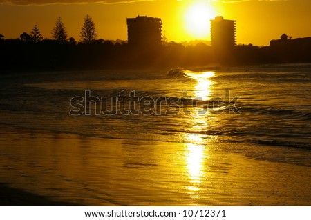 golden glow of waves at a beach during sunset