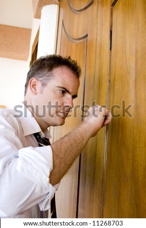 angry young business man knocking on the door