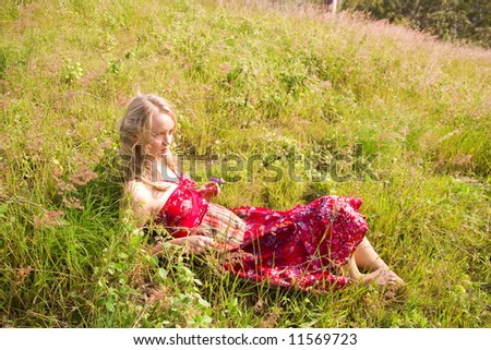 young girl lying in the afternoon sun through the feild