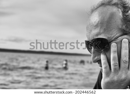 Side profile of mans face with lake in the background