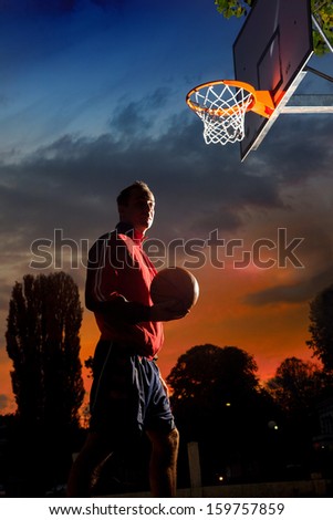 Basketball player silhouette at sunset