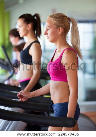 Healthy people doing fitness exercise in a sport center