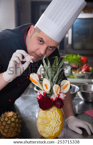 mature chef preparing Arts and fruits