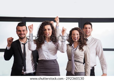 Business team celebrating a triumph with arms up in office